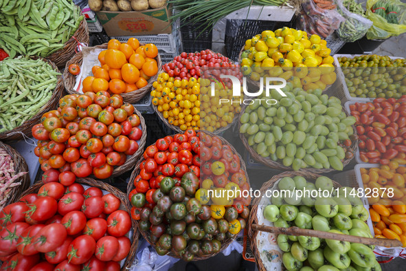 Customers are shopping at a fruit market next to Manzhouli Zhongsu Pedestrian Street in Hohhot, Inner Mongolia, China, on August 15, 2024. 