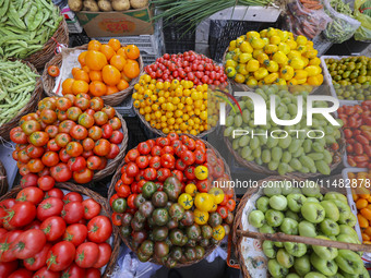 Customers are shopping at a fruit market next to Manzhouli Zhongsu Pedestrian Street in Hohhot, Inner Mongolia, China, on August 15, 2024. (