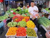 Customers are shopping at a fruit market next to Manzhouli Zhongsu Pedestrian Street in Hohhot, Inner Mongolia, China, on August 15, 2024. (