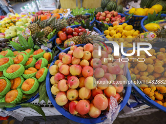 Customers are shopping at a fruit market next to Manzhouli Zhongsu Pedestrian Street in Hohhot, Inner Mongolia, China, on August 15, 2024. (