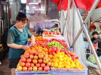 Customers are shopping at a fruit market next to Manzhouli Zhongsu Pedestrian Street in Hohhot, Inner Mongolia, China, on August 15, 2024. (