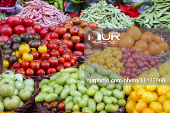 Customers are shopping at a fruit market next to Manzhouli Zhongsu Pedestrian Street in Hohhot, Inner Mongolia, China, on August 15, 2024. 