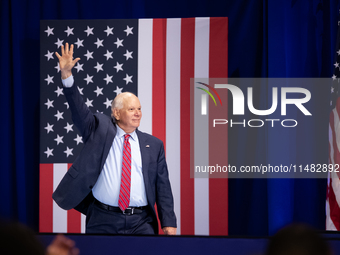 Sen. Ben Cardin (D-MD) waves as he walks on stage at an event announcing reduced Medicare prices for ten widely-used drugs, Upper Marlboro,...