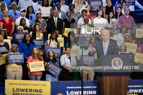 Audience members listen as President Joe Biden delivers remarks at an event announcing reductions in Medicare prices for ten widely-used dru...