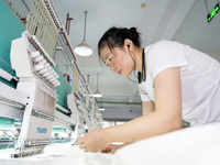 A worker is working on a production line at a workshop of a textile company in Nantong, China, on August 15, 2024. (