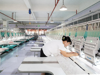 A worker is working on a production line at a workshop of a textile company in Nantong, China, on August 15, 2024. (