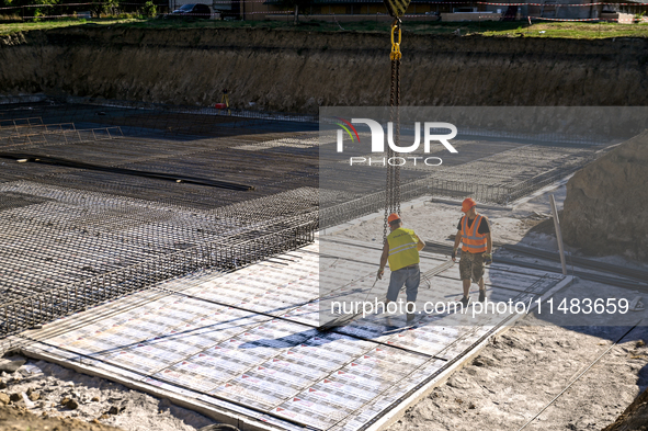 Builders are working at an underground school construction site in the Shyroke community, Zaporizhzhia region, southeastern Ukraine, on Augu...