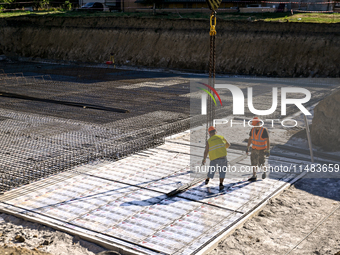 Builders are working at an underground school construction site in the Shyroke community, Zaporizhzhia region, southeastern Ukraine, on Augu...