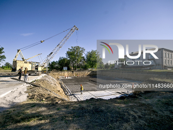 Builders are working at an underground school construction site in the Shyroke community, Zaporizhzhia region, southeastern Ukraine, on Augu...