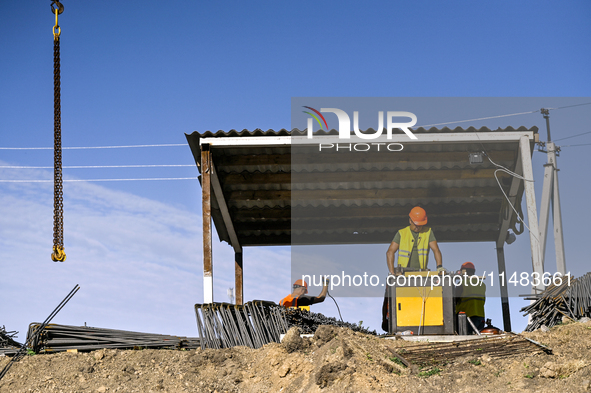 Builders are working at an underground school construction site in the Shyroke community, Zaporizhzhia region, southeastern Ukraine, on Augu...