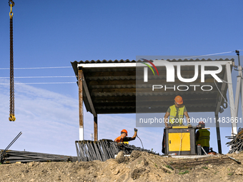 Builders are working at an underground school construction site in the Shyroke community, Zaporizhzhia region, southeastern Ukraine, on Augu...