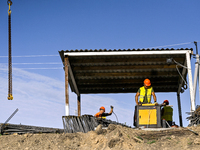 Builders are working at an underground school construction site in the Shyroke community, Zaporizhzhia region, southeastern Ukraine, on Augu...