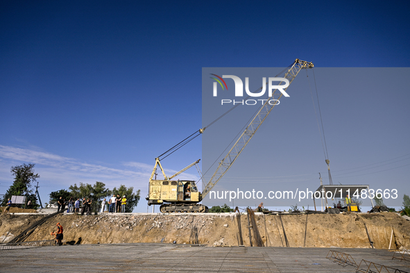 Builders are working at an underground school construction site in the Shyroke community, Zaporizhzhia region, southeastern Ukraine, on Augu...