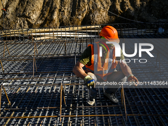 A builder is working at an underground school construction site in the Shyroke community, Zaporizhzhia region, southeastern Ukraine, on Augu...