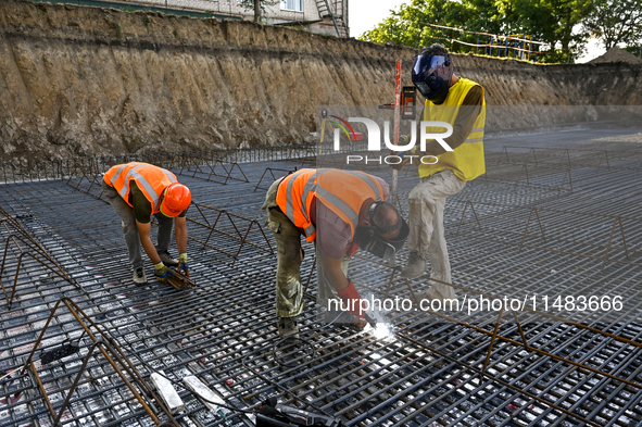 Builders are working at an underground school construction site in the Shyroke community, Zaporizhzhia region, southeastern Ukraine, on Augu...