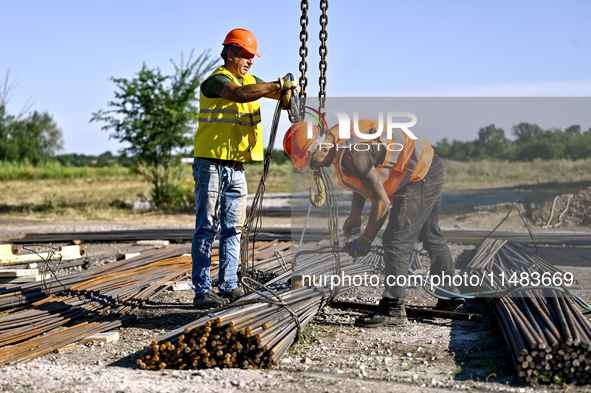 Builders are working at an underground school construction site in the Shyroke community, Zaporizhzhia region, southeastern Ukraine, on Augu...