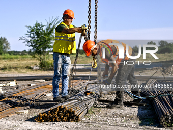 Builders are working at an underground school construction site in the Shyroke community, Zaporizhzhia region, southeastern Ukraine, on Augu...