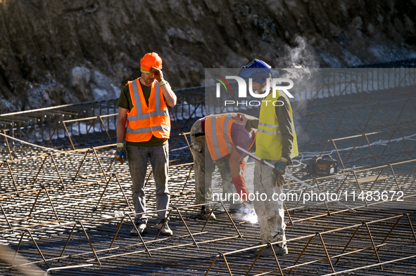 Builders are working at an underground school construction site in the Shyroke community, Zaporizhzhia region, southeastern Ukraine, on Augu...