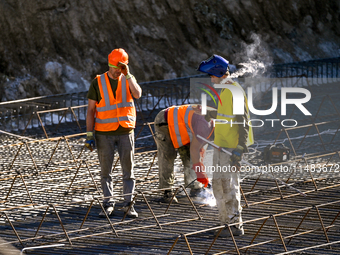 Builders are working at an underground school construction site in the Shyroke community, Zaporizhzhia region, southeastern Ukraine, on Augu...