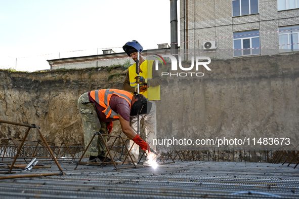 Builders are working at an underground school construction site in the Shyroke community, Zaporizhzhia region, southeastern Ukraine, on Augu...