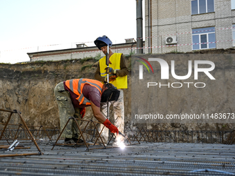 Builders are working at an underground school construction site in the Shyroke community, Zaporizhzhia region, southeastern Ukraine, on Augu...