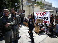 Chained Israeli protesters are holding placards in a protest to call for an end to the war in Gaza, during Britain's Foreign Secretary David...