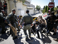 Chained Israeli protesters are arguing with police officers during a protest to call for an end to the war in Gaza, during Britain's Foreign...