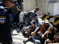 Chained Israeli protesters are arguing with police officers during a protest to call for an end to the war in Gaza, during Britain's Foreign...