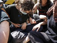 Israeli protesters are chaining themselves in a protest to call for an end to the war in Gaza, during Britain's Foreign Secretary David Lamm...