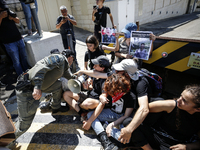 Chained Israeli protesters are arguing with police officers during a protest to call for an end to the war in Gaza, during Britain's Foreign...