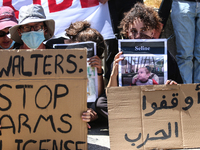 Israeli protesters are holding placards in a protest to call for an end to the war in Gaza, during Britain's Foreign Secretary David Lammy's...