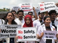 Medical professionals are shouting slogans and holding placards to protest against the rape and murder of a trainee medic at a government-ru...