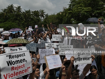 Medical professionals are shouting slogans and holding placards to protest against the rape and murder of a trainee medic at a government-ru...