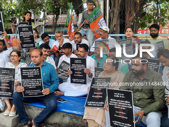 Bharatiya Janata Party (BJP) supporters, along with Siliguri MLA Sankar Ghosh, are holding placards as they are participating in a protest t...