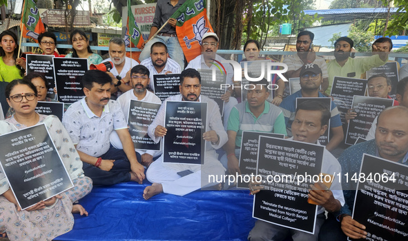 Bharatiya Janata Party (BJP) supporters, along with Siliguri MLA Sankar Ghosh, are holding placards as they are participating in a protest t...