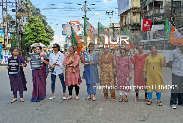 Bharatiya Janata Party (BJP) supporters are blocking a road as they participate in a protest to condemn the rape and murder of a doctor in S...