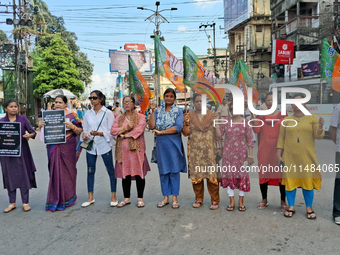 Bharatiya Janata Party (BJP) supporters are blocking a road as they participate in a protest to condemn the rape and murder of a doctor in S...