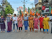 Bharatiya Janata Party (BJP) supporters are blocking a road as they participate in a protest to condemn the rape and murder of a doctor in S...