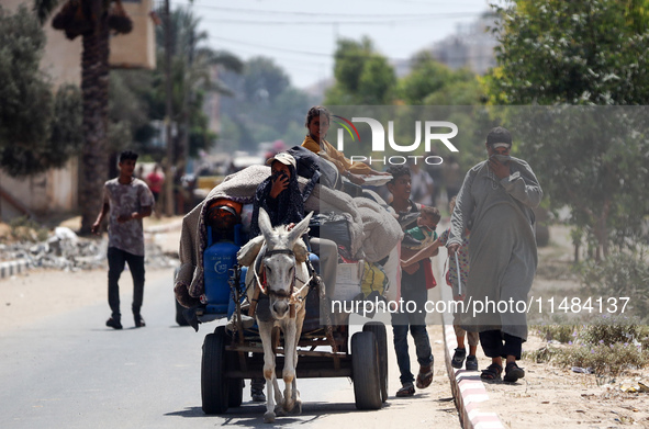 Palestinians are fleeing with their belongings in Deir el-Balah, in the central Gaza Strip, on August 16, 2024, amid the ongoing conflict be...