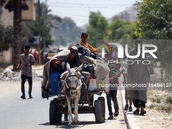 Palestinians are fleeing with their belongings in Deir el-Balah, in the central Gaza Strip, on August 16, 2024, amid the ongoing conflict be...