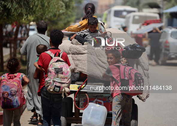 Palestinians are fleeing with their belongings in Deir el-Balah, in the central Gaza Strip, on August 16, 2024, amid the ongoing conflict be...