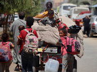 Palestinians are fleeing with their belongings in Deir el-Balah, in the central Gaza Strip, on August 16, 2024, amid the ongoing conflict be...