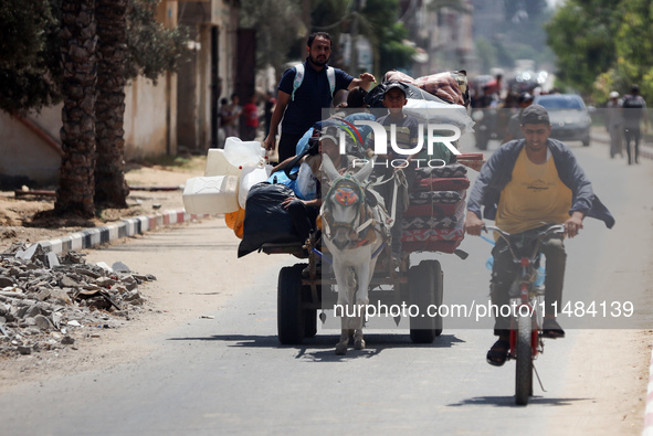 Palestinians are fleeing with their belongings in Deir el-Balah, in the central Gaza Strip, on August 16, 2024, amid the ongoing conflict be...