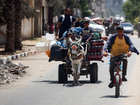 Palestinians are fleeing with their belongings in Deir el-Balah, in the central Gaza Strip, on August 16, 2024, amid the ongoing conflict be...