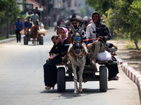 Palestinians are fleeing with their belongings in Deir el-Balah, in the central Gaza Strip, on August 16, 2024, amid the ongoing conflict be...