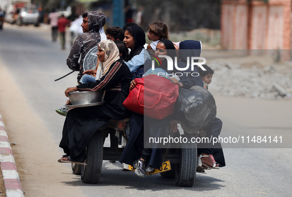 Palestinians are fleeing with their belongings in Deir el-Balah, in the central Gaza Strip, on August 16, 2024, amid the ongoing conflict be...