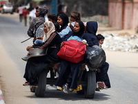 Palestinians are fleeing with their belongings in Deir el-Balah, in the central Gaza Strip, on August 16, 2024, amid the ongoing conflict be...