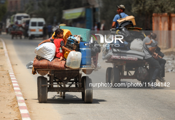 Palestinians are fleeing with their belongings in Deir el-Balah, in the central Gaza Strip, on August 16, 2024, amid the ongoing conflict be...