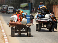 Palestinians are fleeing with their belongings in Deir el-Balah, in the central Gaza Strip, on August 16, 2024, amid the ongoing conflict be...