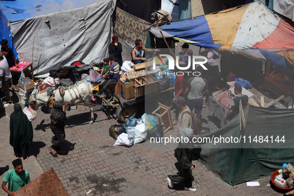 Palestinians are fleeing with their belongings in Deir el-Balah, in the central Gaza Strip, on August 16, 2024, amid the ongoing conflict be...